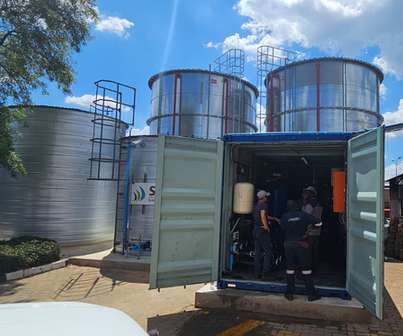 Carletonville: treatment enclosure beside steel storage tanks
