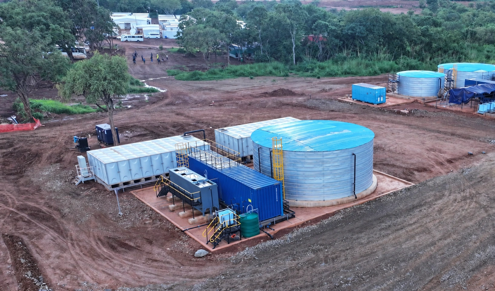 Kurmuk project photograph showing the containerised treatment plant and water storage